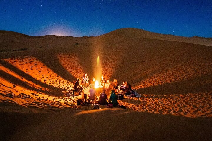 Experience the magic of the Dubai desert under starlit skies where cozy gatherings around the fire invite shared stories and unforgettable memories complemented by rich cultural performances and a delightful BBQ feast.
